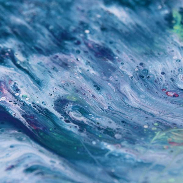 Abstract art representing energy flow with coral and turquoise wave patterns.